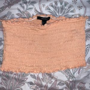 Peach colored strapless crop top